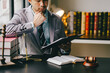 © Suphakant - Male consultant or lawyer working in the office legal concept Advice on justice and the law Male judge in courtroom