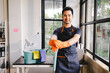 © Suphakant - male cleaning staff Hold wipes and a bottle of disinfectant spray. and cleaning equipment