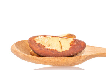 Wall Mural - Several Brazil nuts with a wooden spoon, close-up, isolated on a white background.