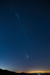 Wall Mural - a bright meteor streaks across the night sky
