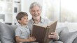 © mirifadapt - smiling elderly man sitting on sofa with child, holding book in hands