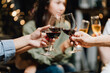 © Kritdanai - Cheers to Connection:  Close-up shot of hands clinking wine glasses, capturing the warmth and camaraderie of a celebratory moment between friends.
