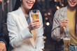 © Kritdanai - Cheers to Success: A group of young professionals celebrate a successful evening with drinks and laughter. The warm lighting creates a cozy and inviting atmosphere.