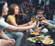 © Kritdanai - Evening Cheers:  Friends toast to good times with glasses of wine, beer, and other beverages.  The vibrant scene is captured in a warm.
