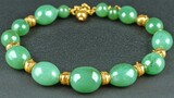 Jade bracelet on dark background, elegant jewelry, close-up shot.