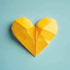 Poster - A bright yellow origami heart resting on a calm blue background, perfect for representing love and warmth