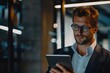 © Anjali - Handsome businessman using his tablet in the office