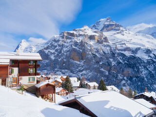 Wall Mural - Murren village, Switzerland. Winter mountain landscape. Village among the mountains. Chalets and vacation homes. High cliffs and snow. View of the mountain in Switzerland.