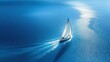 © alisluch - A white sailboat gliding gracefully across a calm, deep blue ocean with shimmering sunlight reflecting on the water