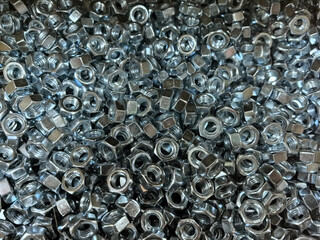 Poster - Collection of shiny metal nuts in a close-up view for industrial use