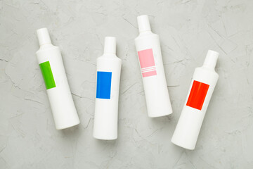 Sticker - Shampoo bottles on concrete background, top view