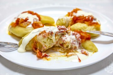 Wall Mural - Classic Ukrainian food, perohê or veréneki stuffed with potatoes and cottage cheese and cooked, served with different types of sauce and salted and sour cream