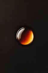 Poster - Close-up shot of a single liquid drop on a dark background, suitable for science and technology illustrations