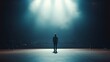 © VK Studio - A solitary figure stands illuminated on stage beneath a spotlight, surrounded by darkness and anticipation from an unseen audience.