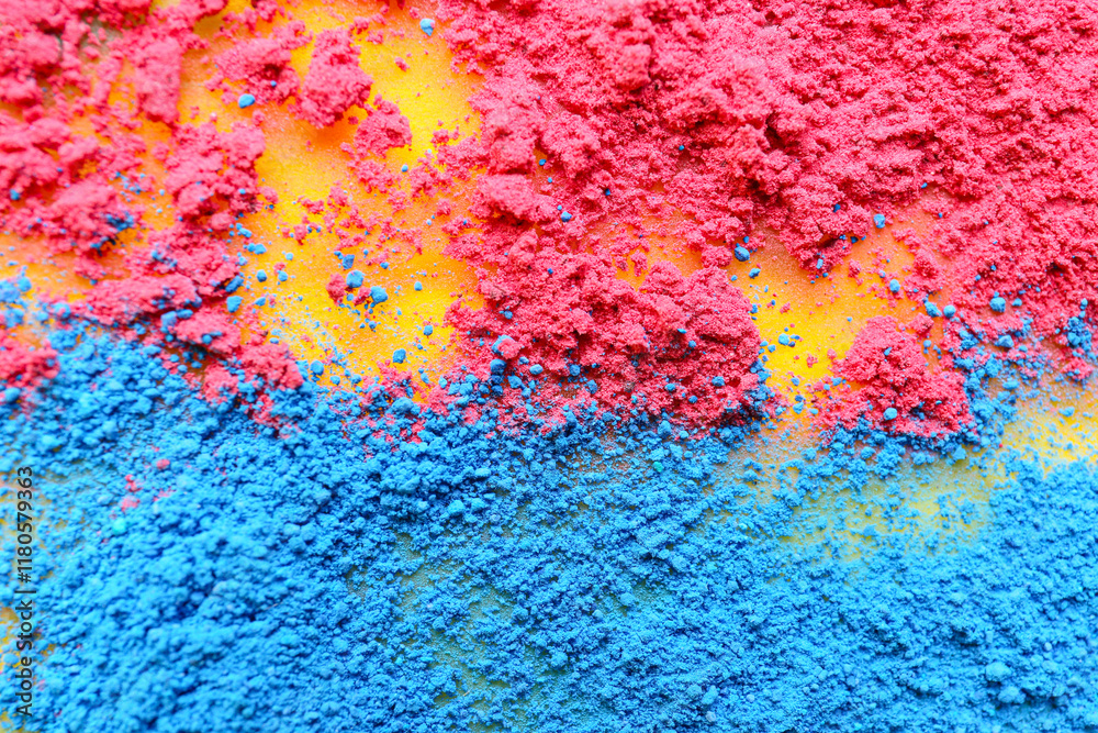 Scattered color powder pigments on yellow background, closeup