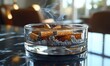 © Ali - Glass ashtray, smoldering cigarettes, smoke.