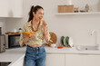 © Pixel-Shot - Young girl eating nachos in kitchen