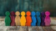 © tashechka - Vibrant wooden figures of various colors are aligned together, highlighting their unique shapes on a textured wooden background