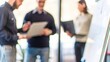 © Jo - Team Collaboration Blur - Blurred background showing a team of professionals collaborating on a project.