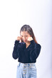 © yani-hidayat  - A young Asian Woman in a Black Velvet Top and Denim Jeans making expressive gestures Isolated on white background