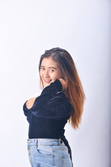 Wall Mural - A young Asian Woman in a Black Velvet Top and Denim Jeans making expressive gestures Isolated on white background