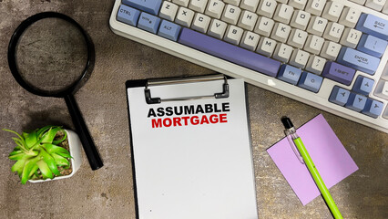 Wall Mural - Concept of Assumable Mortgage write on paperwork isolated on Wooden Table.