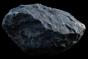 Wall Mural - Large dark gray boulder isolated on black background.