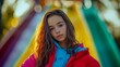 © Olsek - A young girl with long hair poses confidently at a colorful playground. Her vibrant outfit contrasts beautifully with the vivid backdrop. Joy and youth are captured. Generative AI