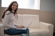 © Ojas - Woman using laptop computer, working at home. Casual business, freelance work, distance studying, internet marketing, meeting online concept