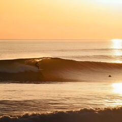 A photo of a surfer catching a wave under the golden light of a setting sun