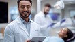 © Nataliia_Trushchenko - Man in a white lab coat is smiling and holding a tablet in front of a woman in a dental chair