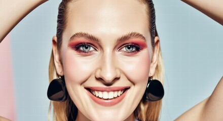 Wall Mural - Smiling caucasian young female with red eyeshadow and earrings