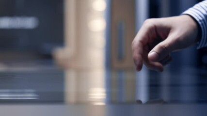 Close-up view about an interactive modern touch interface when a man using it.