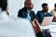 © Jacob Lund - Professional men in a business meeting in a boardroom setting with laptops and documents