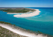 © AmazingAerialAgency - Aerial view of beautiful beach and serene inlet with lush green landscape, Willies Creek, Kimberley Region, Australia.