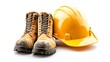 © Engineer - A construction hard hat with a pair of work boots and gloves displayed on a pristine white background, symbolizing readiness for the job.