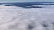 © AmazingAerialAgency - Aerial view of serene misty mountains and soft clouds under a dreamy sky, Eichenzell, Germany.