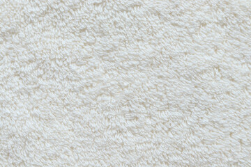 close-up of soft beige textile texture with a fluffy, curly surface, ideal for backgrounds, fabric d