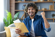 © Liubomir - Winning good news, man with mail envelope looking joyfully at camera, sitting in living room at home, received notification message by mail about good results.