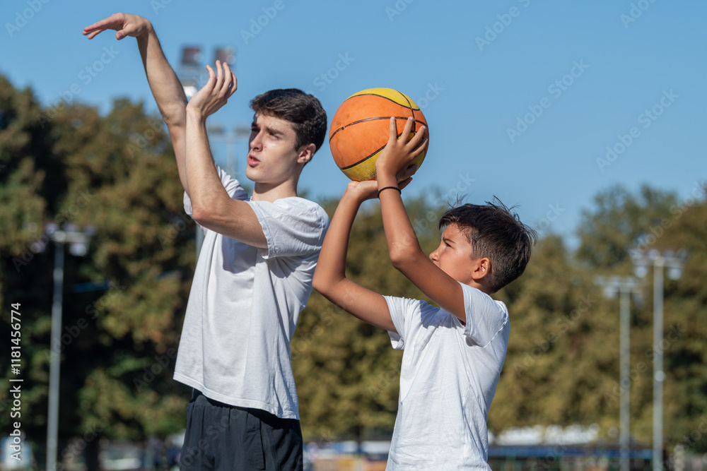 Outdoor Basketball Training For Kids Featuring A Coach Teaching A