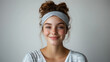 © Julia Zarubina - smiling young european woman in pajamas, with a headband on her head on white background