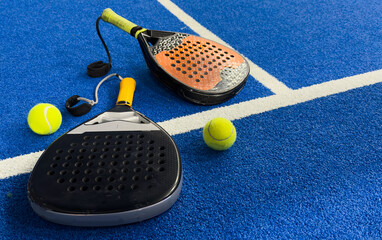 Poster - padel racket on a padel blue court with a ball