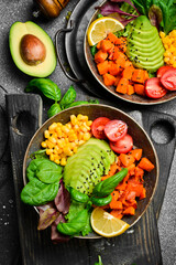 Wall Mural - Buddha bowl. Healthy vegetable lunch with avocado, pumpkin, corn and lettuce. Vegetarian salad. Healthy balanced eating.