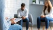 © olga_demina - Psychologist is taking notes on notepad during a couple psychotherapy session, helping patients to solve their relationship problems