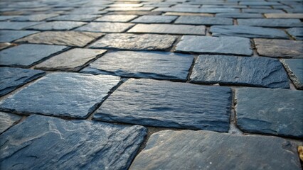 Poster - A closeview of weathered slate pavers exhibiting a stunning range of shades from deep blue to charcoal. The textured surface captures the nuances of natural stone while the