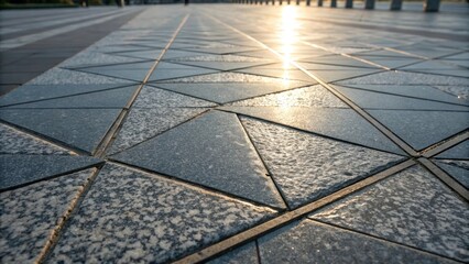 Poster - A detailed view of polished granite pavers reflecting the sunlight and revealing intricate crystalline structures. The geometric layout creates a modern aesthetic with sharp lines