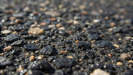 Poster - A macro shot of the asphalt mixture itself revealing the shiny black grains and varying textures with small pieces of gravel and sand embedded throughout captured in natural light