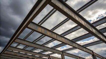 Aufkleber - An intimate view of overlapping steel beams with their lengths creating a visually compelling pattern against the backdrop of a cloudy sky reflecting the interplay of light and