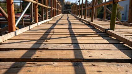 Aufkleber - An intricate view of the wooden planks forming the walking surface of the scaffolding splintered edges and a rich weathered texture. Shadows play across the surface with