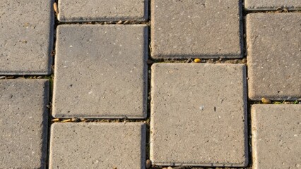Aufkleber - An overhead shot capturing a bundle of rectangular sidewalk slabs each marked by a unique pattern of aggregate peeking through the surface. The image focuses on the corners where
